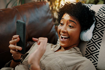 Shot of a Girl with headphones and mobile which shows how useful digitalization and beneficiary is.