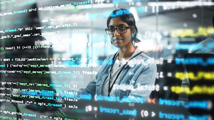 Portrait of a woman professional IT Programmer Working on Desktop Computer.