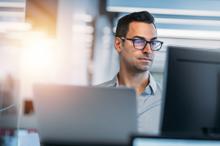 Shot of a man working on computer. Concept is benefits broker working to grow their business.
