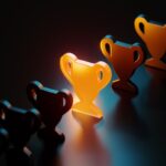 Trophy symbol glowing amid black trophy symbols on black background.